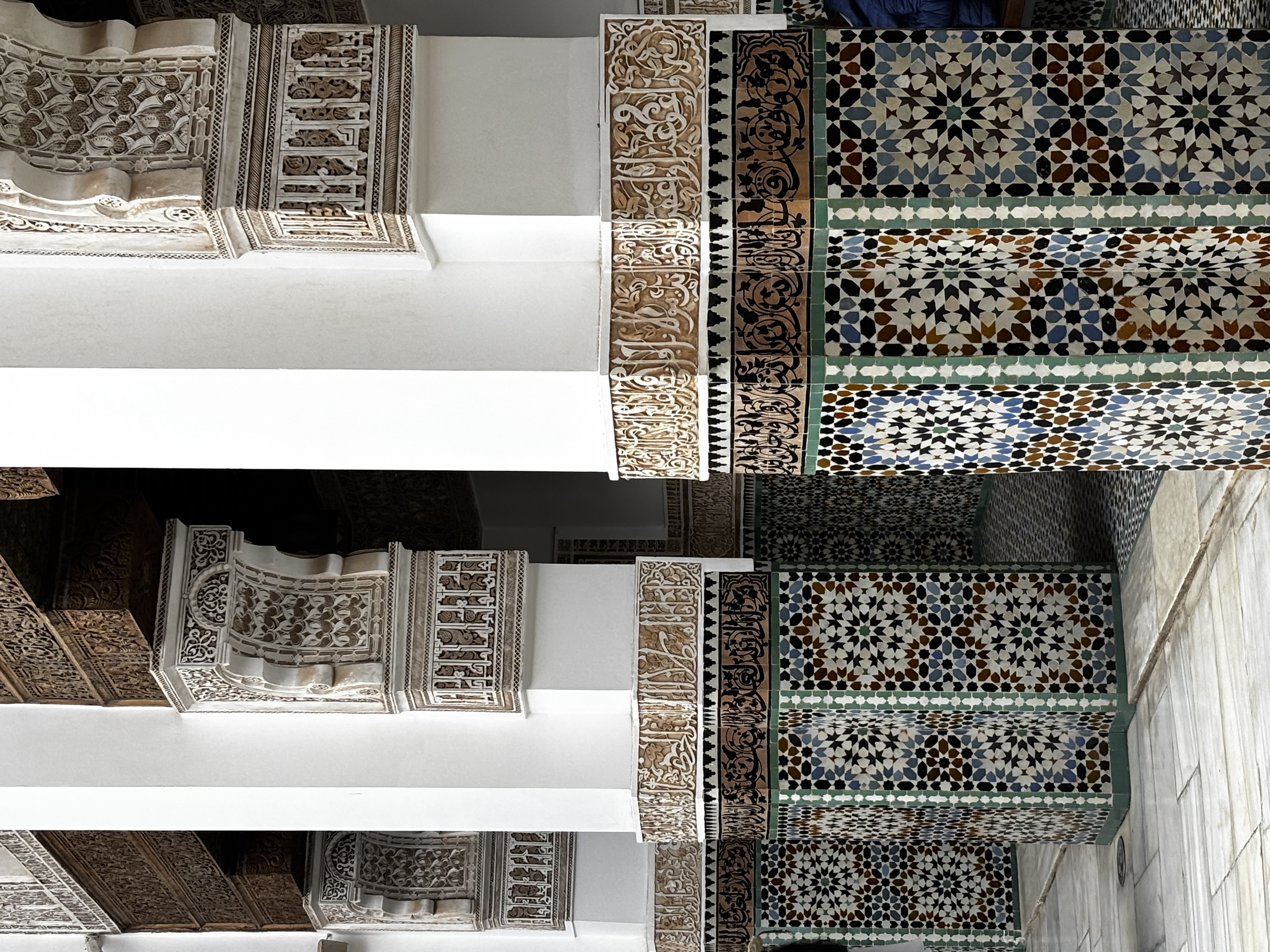 Tiled columns with intricate carving in Madrasa Ben Youssef seen during our two days in Marrakech