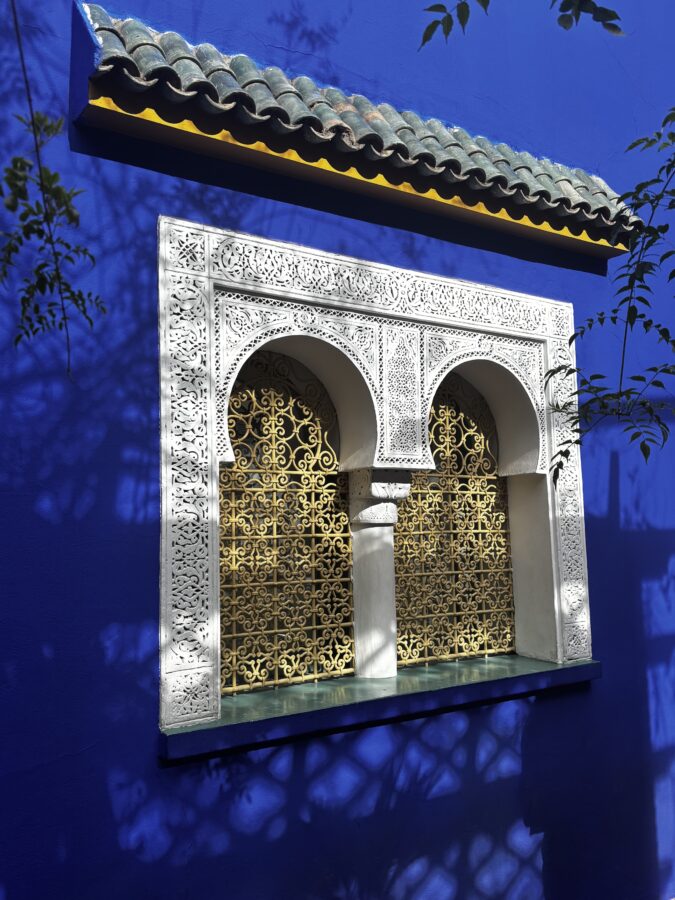 Blue wall with carved wood window, seen during our two days in Marrakech