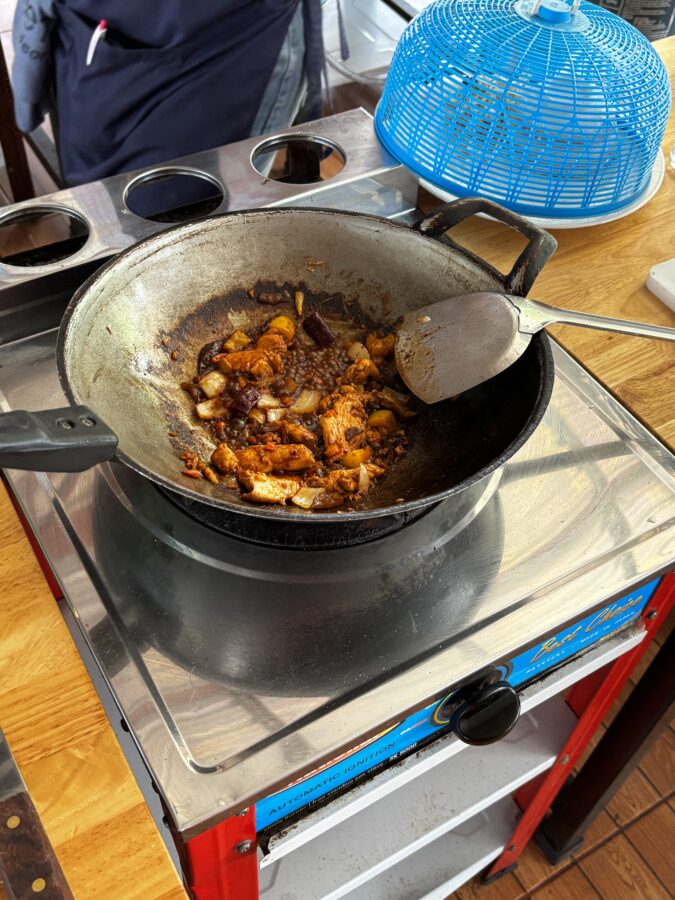 Wok with stir-fry in Thai cooking class