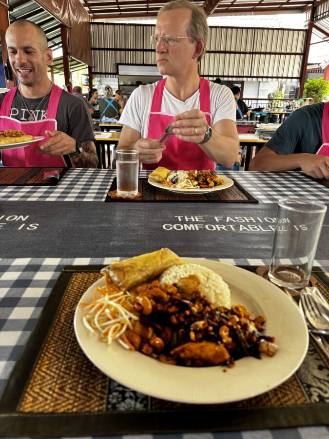 Cooking class in Chiang Mai: plate of food and two men sitting at a table