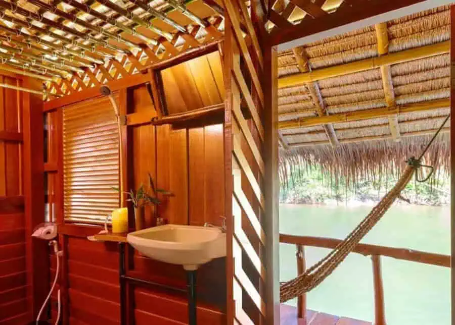 Inside of floating rooms on jungle raft: sink and hammock