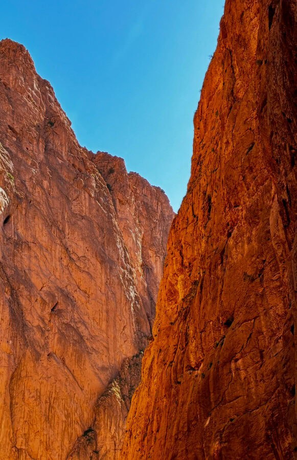 Stunning red sandstone cliffs with clear blue sky, perfect for outdoor travel enthusiasts.