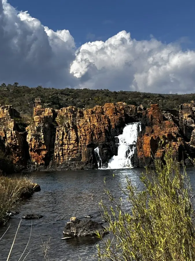 Waterfall coming down a mountain in the distance at Bourke's Luck Potholes, South Africa