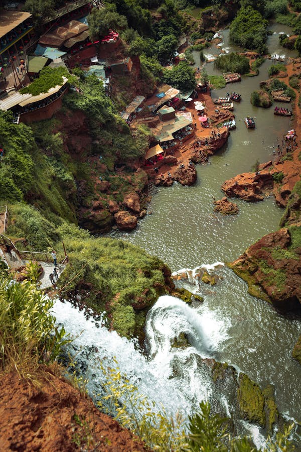 A breathtaking aerial view of Ouzoud Waterfalls cascades surrounded by lush greenery in Morocco. Can be seen on a day tour from Marrakech