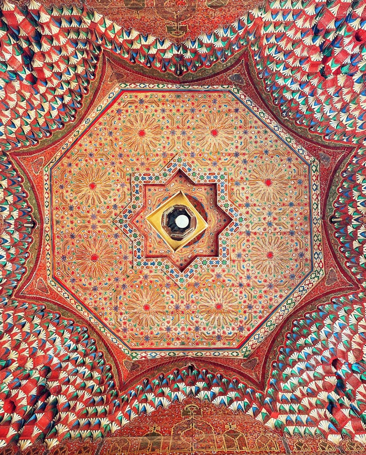 Stunning geometric and floral patterns on the ornate ceiling of Bahia Palace, Marrakesh, Morocco.