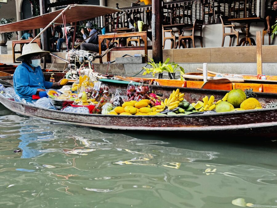 Flat boat loaded with mangos, bananas and other fruit, part of a floating market in Thailand 