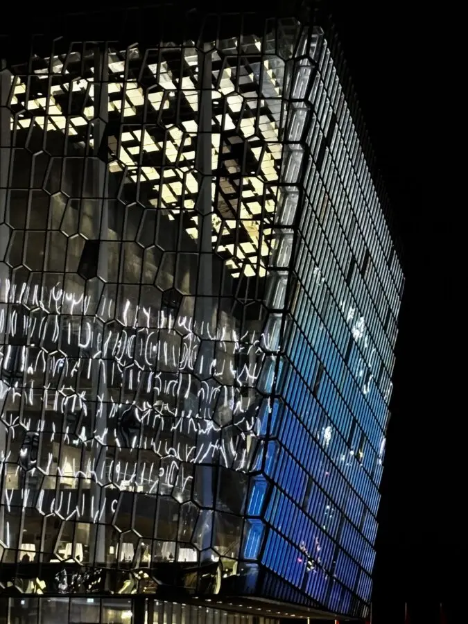 Harpa building in Reykjavík, Iceland, seen up-close in the dark, lit in blue