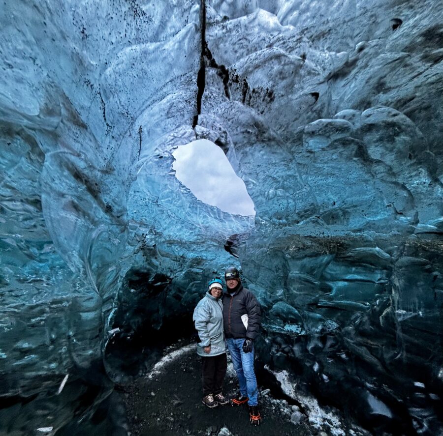 Man and woman in their fifties standing in a blue Ice cave in Iceland