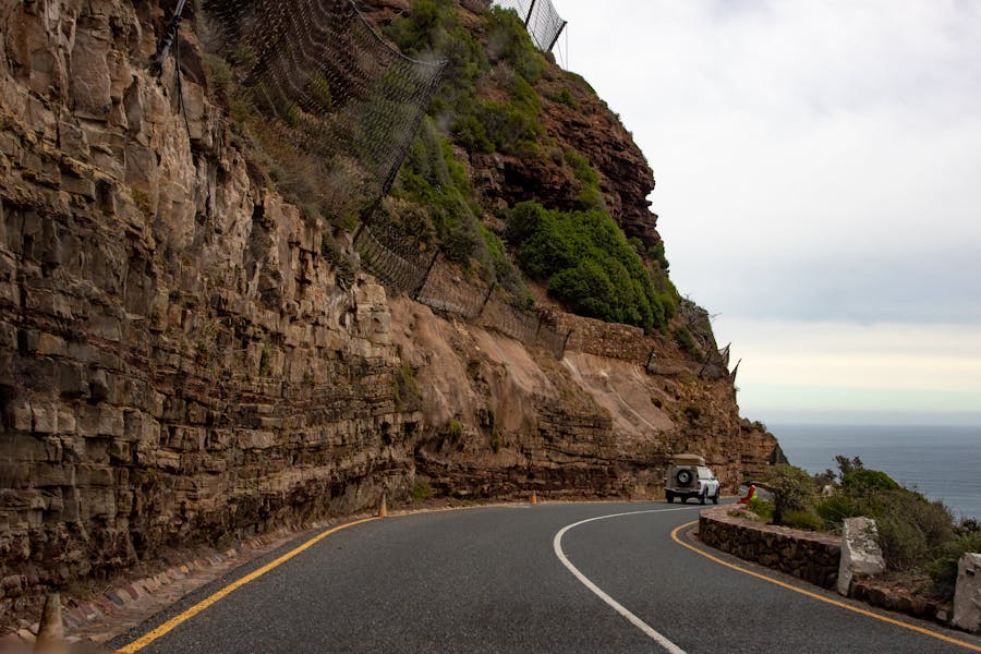 A serene road winding through Chapman's Peak with views of the ocean in Cape Town, South Africa.