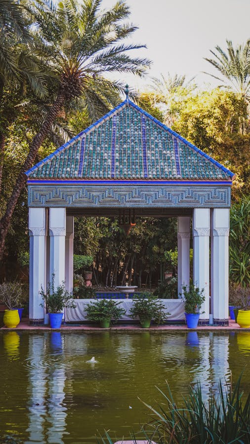 A vibrant pavilion at Majorelle Garden, Marrakech, surrounded by lush greenery.