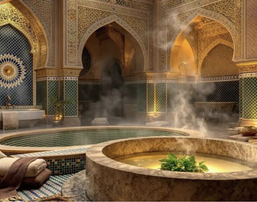 Beautifully tiled hammam with steam rising from pool