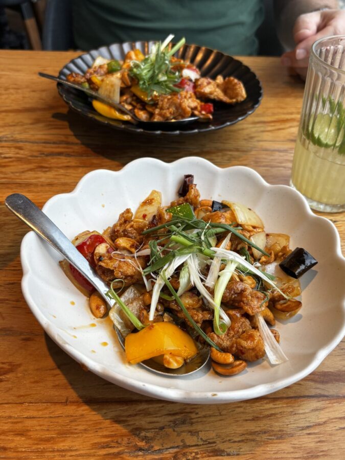 A plate of Thai food: rice, colourful vegetables, chicken and a glass of lemon juice. This started my love for Thai food on my first day in Bangkok