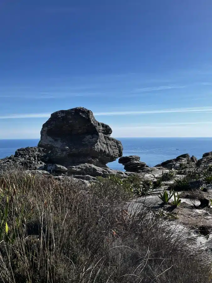 Large rock on top of Table Mountain with a view over the ocean