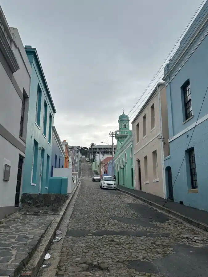 Row of pastel-coloured houses on both sides of a street. Bo Kaap, Cape Town 