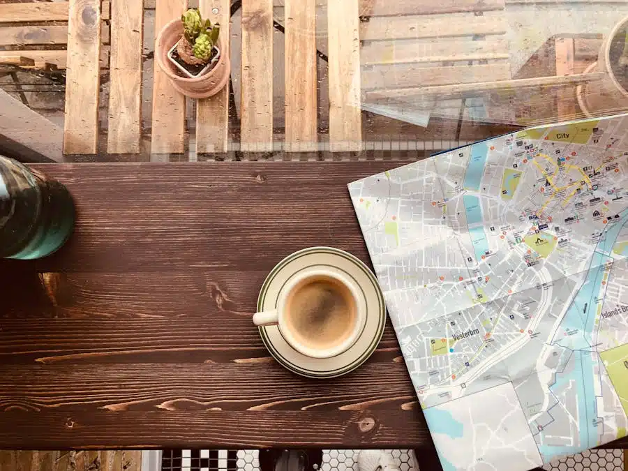 Cup of coffee and a city map on a wooden table by the window in Copenhagen's cozy cafe.