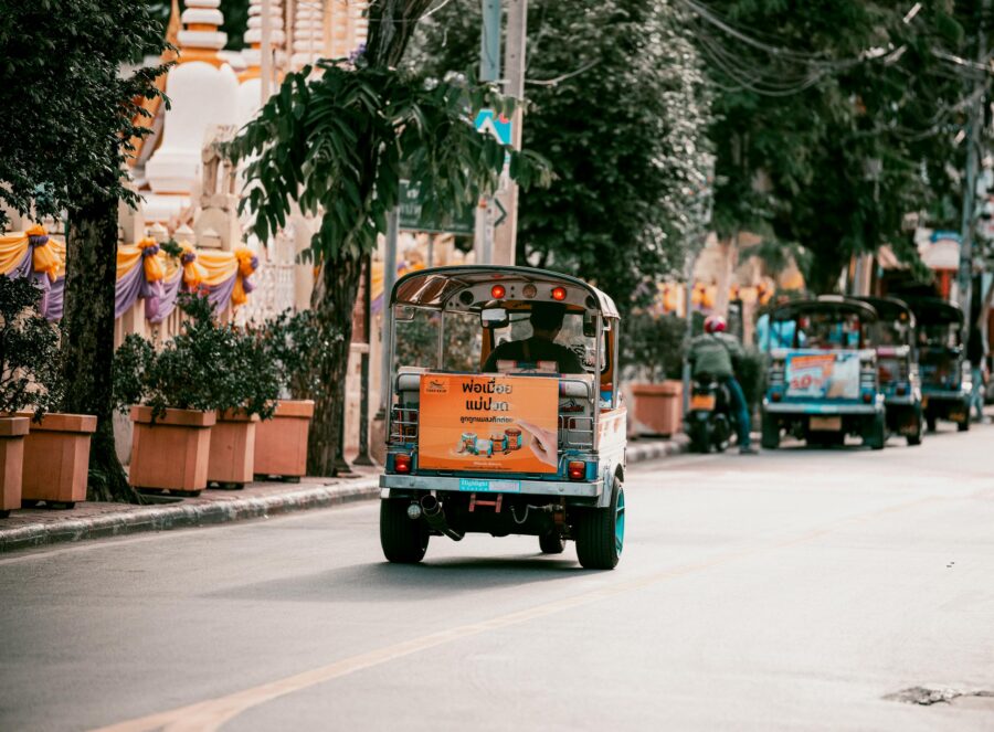 Vibrant Bangkok street filled with colorful tuk tuks showcasing urban transportation in Thailand. 