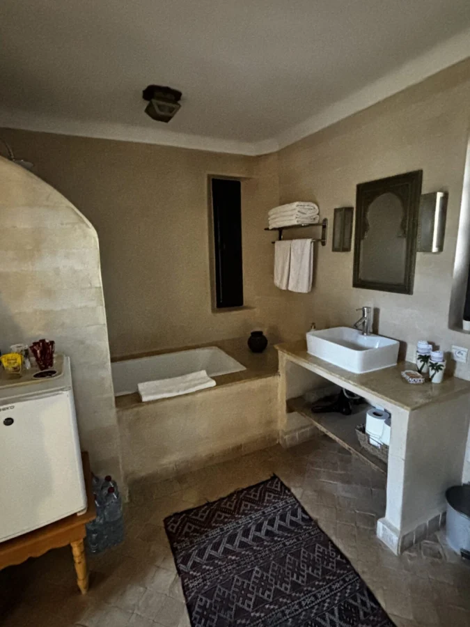 Photo: Tales From The Road Ahead. Bathroom in Garden cottage Villa Dinari, Marrakech. Tub, toiletries, decoration.