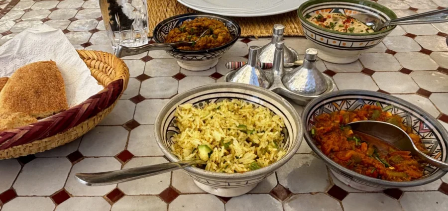 Photo: Tales From The Road Ahead. Mezze-style food in small bowls on a table outside. Villa Dinari, Marrakech