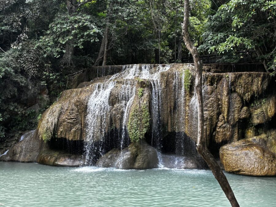 Photo: Talesfromtheroadahead. Level two at Erawan Falls in Kanchanaburi Province, Thailand. Water falling over broad rocks into a turquoise pool, surrounded by jungle. This is where we did a lot of swimming.