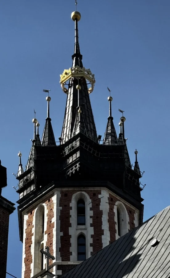 Photo: Tales From The Road Ahead. Steeple of church near in the old town. If you look really hard you can see the trumpet player in one of the windows. Kraków, Poland.