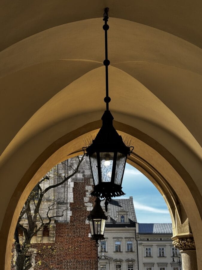 Photo: Tales From The Road Ahead. Beautifully decorated street lantern seen through a doorway in Rynek Główny, Kraków - the main square. 