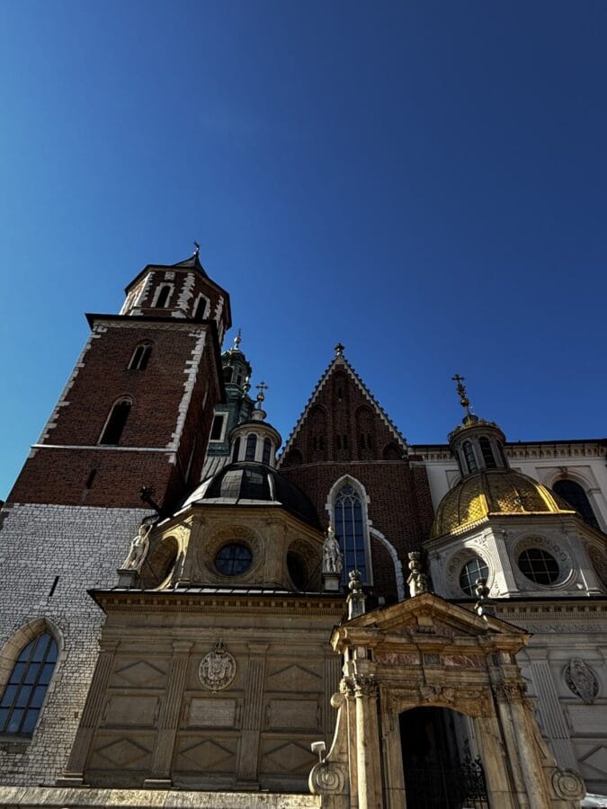Photo: Tales From The Road Ahead. Wawel Castle in Kraków, Poland. Gold-plated rooftops, turrets and decorations against a bright blue sky. If you only have one day in Kraków, go here. 