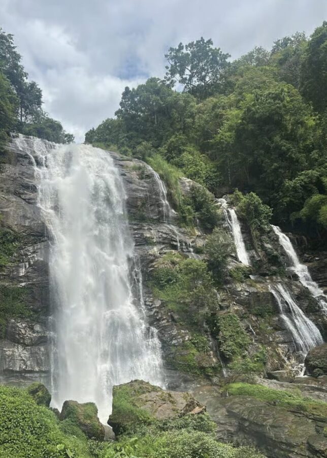 Waterfall in Doi Inthanon National Park, Thailand. Green lush scenery around it. 