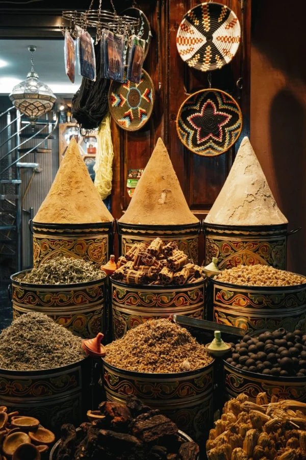 Vibrant spices displayed in a traditional market in Marrakesh, Morocco.