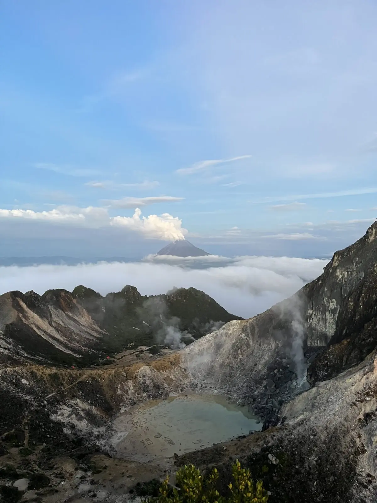 Photo Talesfromtheroadahead View from above of the Sibayak crater, Sumatra, with smoking Mount Sinabung in the background